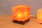 Cube Himalayan salt lamp on wooden base